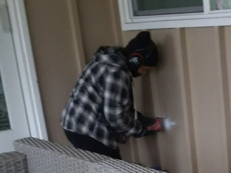 Professional electrician installing an exterior outlet in St. Anthony