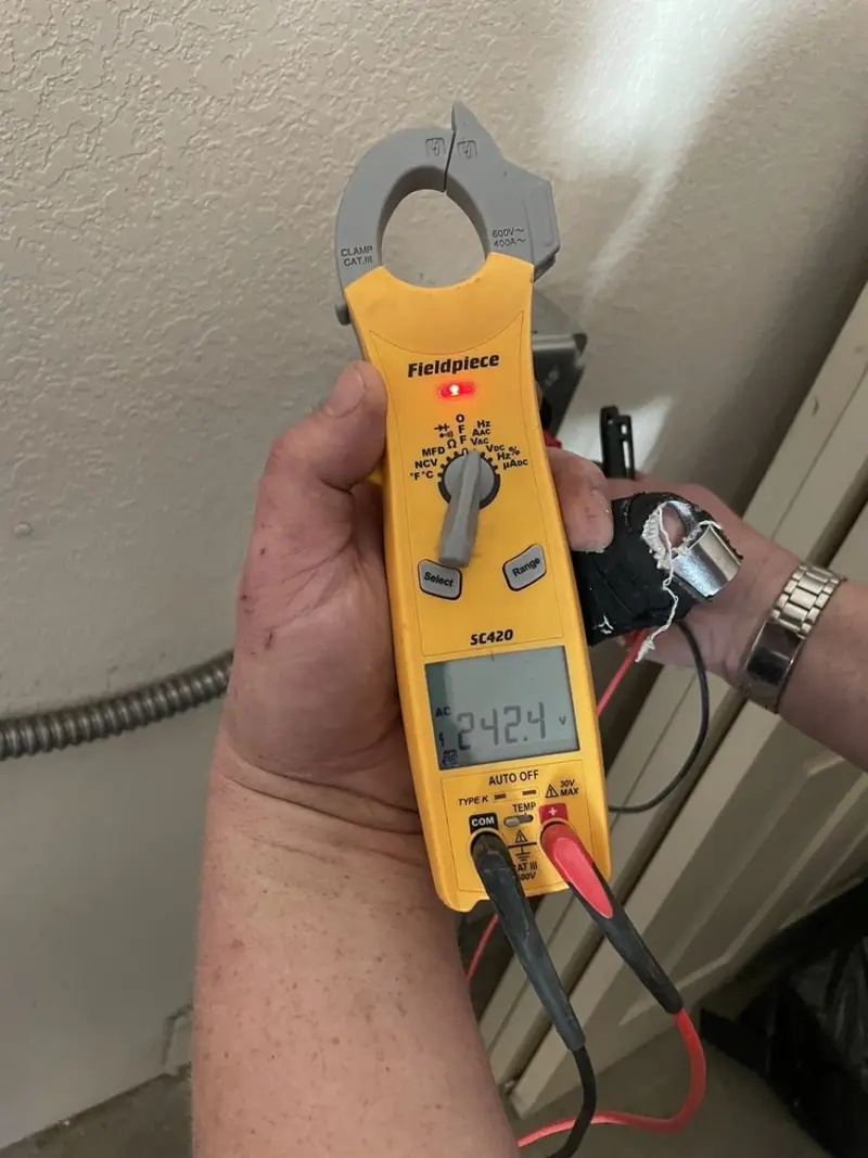 Voltage testing with clamp meter during Ceiling Fan Installation in St. Anthony